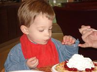  Daniel Dunster Guzzi, her youngest grand-nephew in attendance, is shown with a special treat during the party.